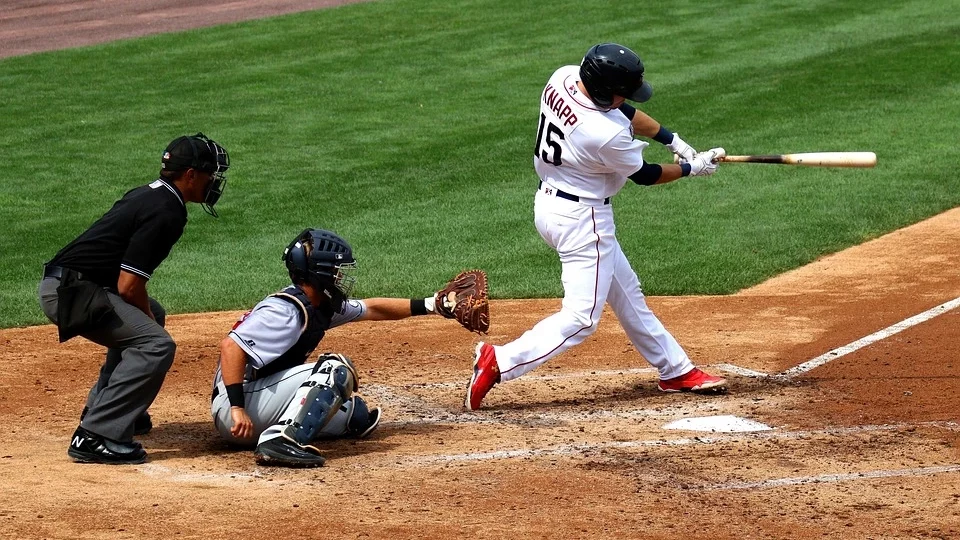 Players in action during a baseball game at the stadium, showcasing the intensity of the sport.